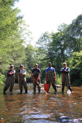 group of natural resources students standing in the river